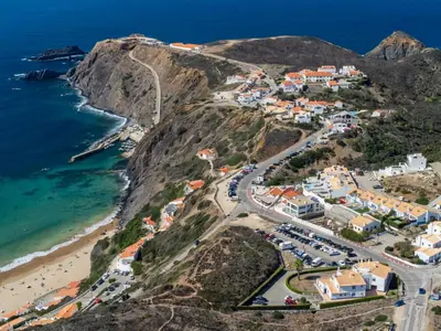 an aerial view of a town on a mountain next to the ocean at Aloha Apartment Arrifana in Praia da Arrifana