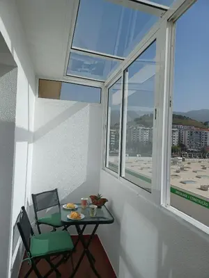 a small table and chair in a room with a window at Apartamento Oliveira in Funchal
