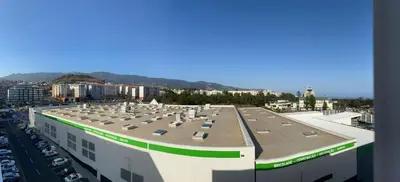 a large building with a lot of pigeons on the roof at Apartamento Oliveira in Funchal