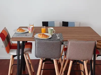 a wooden table with two plates of food on it at Apartamento Oliveira in Funchal