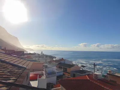 a view of a city with the ocean in the background at villa com piscina entre o mar e as montanhas in Paul do Mar