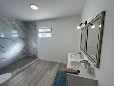 a bathroom with a sink and a mirror at villa com piscina entre o mar e as montanhas in Paul do Mar