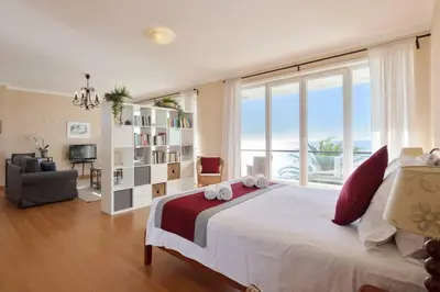 a bedroom with a large bed and a large window at Casa del Mar - Amazing Villa with Sea View & Pool in Luz