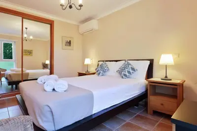 a bedroom with a large bed with towels on it at Casa del Mar - Amazing Villa with Sea View & Pool in Luz