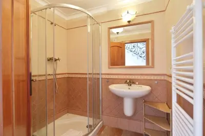 a bathroom with a sink and a glass shower at Casa del Mar - Amazing Villa with Sea View & Pool in Luz