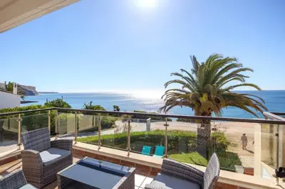 a balcony with chairs and a view of the beach at Casa del Mar - Amazing Villa with Sea View & Pool in Luz