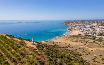 an aerial view of a beach with a lighthouse at Casa del Mar - Amazing Villa with Sea View & Pool in Luz
