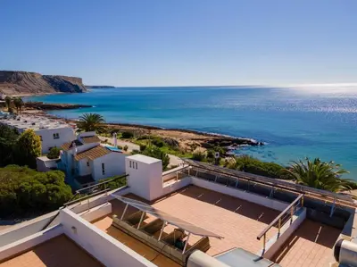a view of the ocean from a house at Casa del Mar - Amazing Villa with Sea View & Pool in Luz