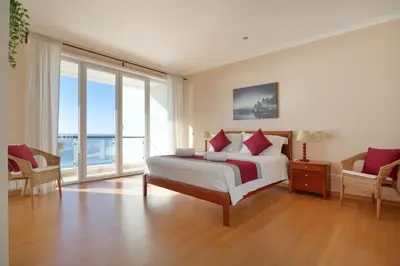 a bedroom with a bed with a view of the ocean at Casa del Mar - Amazing Villa with Sea View & Pool in Luz