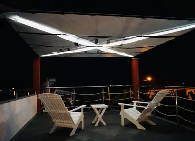 two chairs sitting on the deck of a ship at night at Casa MaBu by Your Madeira Rentals in Paul do Mar