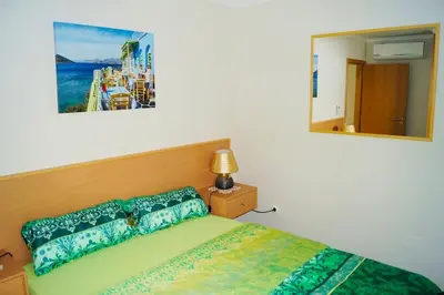 a bedroom with a bed and a mirror at Casa MaBu by Your Madeira Rentals in Paul do Mar