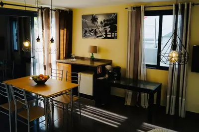 a kitchen with a table and a desk and a dining room at Casa MaBu by Your Madeira Rentals in Paul do Mar