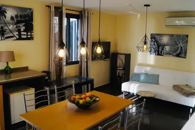 a living room with a bowl of fruit on a table at Casa MaBu by Your Madeira Rentals in Paul do Mar