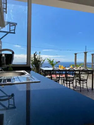 a kitchen with a view of the ocean at Mine House in Calheta