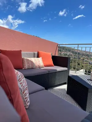 a patio with a couch on a balcony at Mine House in Calheta