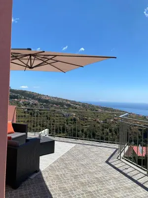 a patio with a view of the ocean from a house at Mine House in Calheta