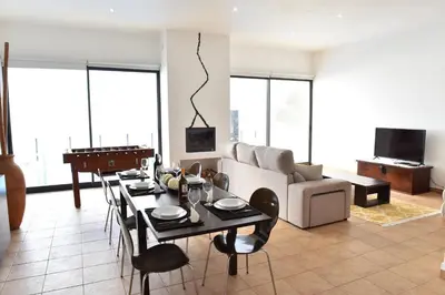 a living room with a table and a couch at Charming Villa in Fajã da Ovelha with Private Pool in Fajã da Ovelha