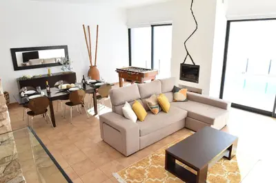 a living room with a couch and a table at Charming Villa in Fajã da Ovelha with Private Pool in Fajã da Ovelha