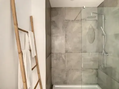a bathroom with a shower with a glass door at Uptown Apartment by LovelyStay in Funchal