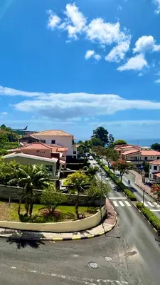 an empty city street with palm trees and buildings at Amazing SEA LIGHT Apartment, close to the beach. in Santa Cruz