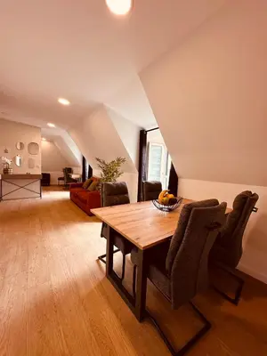 a living room with a wooden table and chairs at Living Funchal Executive in Funchal