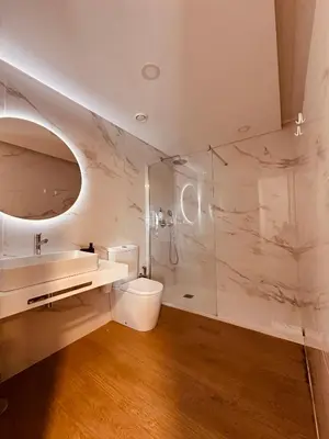 a bathroom with a shower and a toilet and a sink at Living Funchal Executive in Funchal