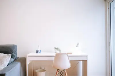 a white desk with a lamp next to a couch at Apartamento Feliz by Amazing Madeira in Funchal