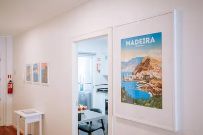 a door into a room with a poster on the wall at Apartamento Feliz by Amazing Madeira in Funchal