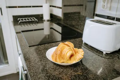 a plate of bread on a counter in a kitchen at Apartamento Feliz by Amazing Madeira in Funchal