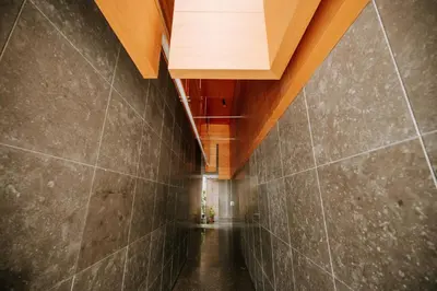 a hallway with a wooden ceiling and a tile wall at Apartamento Feliz by Amazing Madeira in Funchal