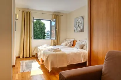 a bedroom with two beds and a window at Largo dos Milagres, a Home in Madeira in Machico