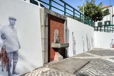 a door with a statue on the side of a building at Largo dos Milagres, a Home in Madeira in Machico