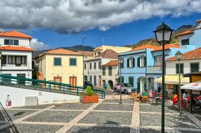 a street in a town with colorful buildings at Largo dos Milagres, a Home in Madeira in Machico