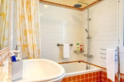 a bathroom with a tub and a sink at Largo dos Milagres, a Home in Madeira in Machico