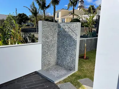 a metal gate on the side of a house at Villa Sea View in Arco da Calheta
