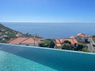 a swimming pool with a view of the ocean at Villa Sea View in Arco da Calheta