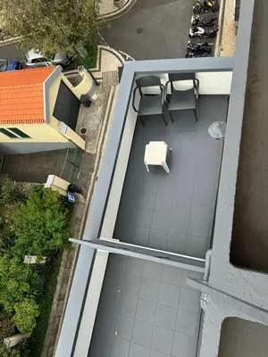 an overhead view of a balcony with a table and bench at Alojamento Central I - Funchal in Funchal