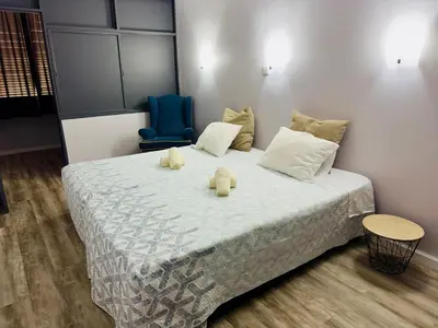 a bedroom with a bed with two teddy bears on it at Alojamento Central I - Funchal in Funchal