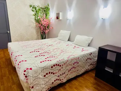 a bedroom with a bed with a vase of flowers at Alojamento Central I - Funchal in Funchal