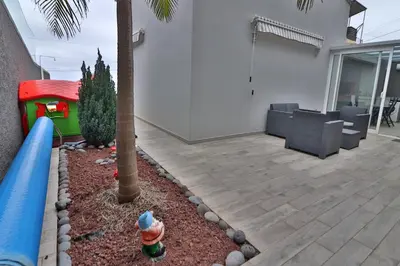 a play area with a slide and a palm tree at Vila Castro in Estreito da Calheta