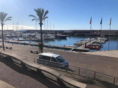 a car parked next to a marina with boats at Vila Castro in Estreito da Calheta