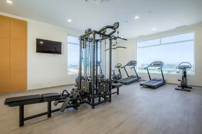 a gym with cardio equipment in a room with a window at Casa da Boa Vida at Boa Vista Golf Resort Bayview in Lagos