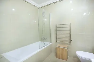 a bathroom with a tub and a toilet and a sink at Casa da Boa Vida at Boa Vista Golf Resort Bayview in Lagos