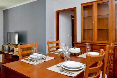 a dining room with a table with plates and glasses at Lido Gardens Funchal in Funchal