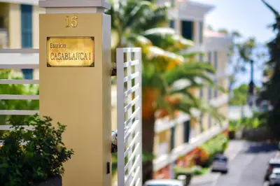 a clock on the side of a building on a street at Lido Gardens Funchal in Funchal