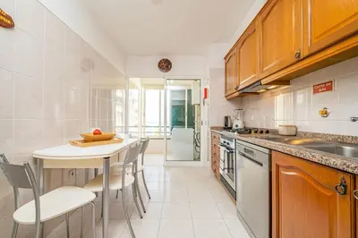 a kitchen with a table and some chairs in it at Bellemar Apartment by Homie in Funchal