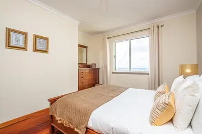 a bedroom with a bed and a window at Bellemar Apartment by Homie in Funchal