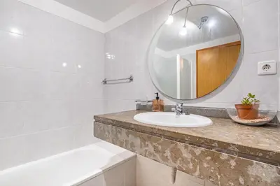 a bathroom with a sink and a mirror at Bellemar Apartment by Homie in Funchal