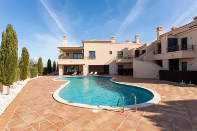 a kitchen and living room with a table and chairs at CoolHouses Algarve, Luz 2 bed elegant flat, private pool & garden, SPA facilities, Mar da Luz 19 in Luz