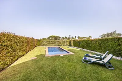 a bedroom with a large bed and a flat screen tv at CoolHouses Algarve, Luz 2 bed elegant flat, private pool & garden, SPA facilities, Mar da Luz 19 in Luz